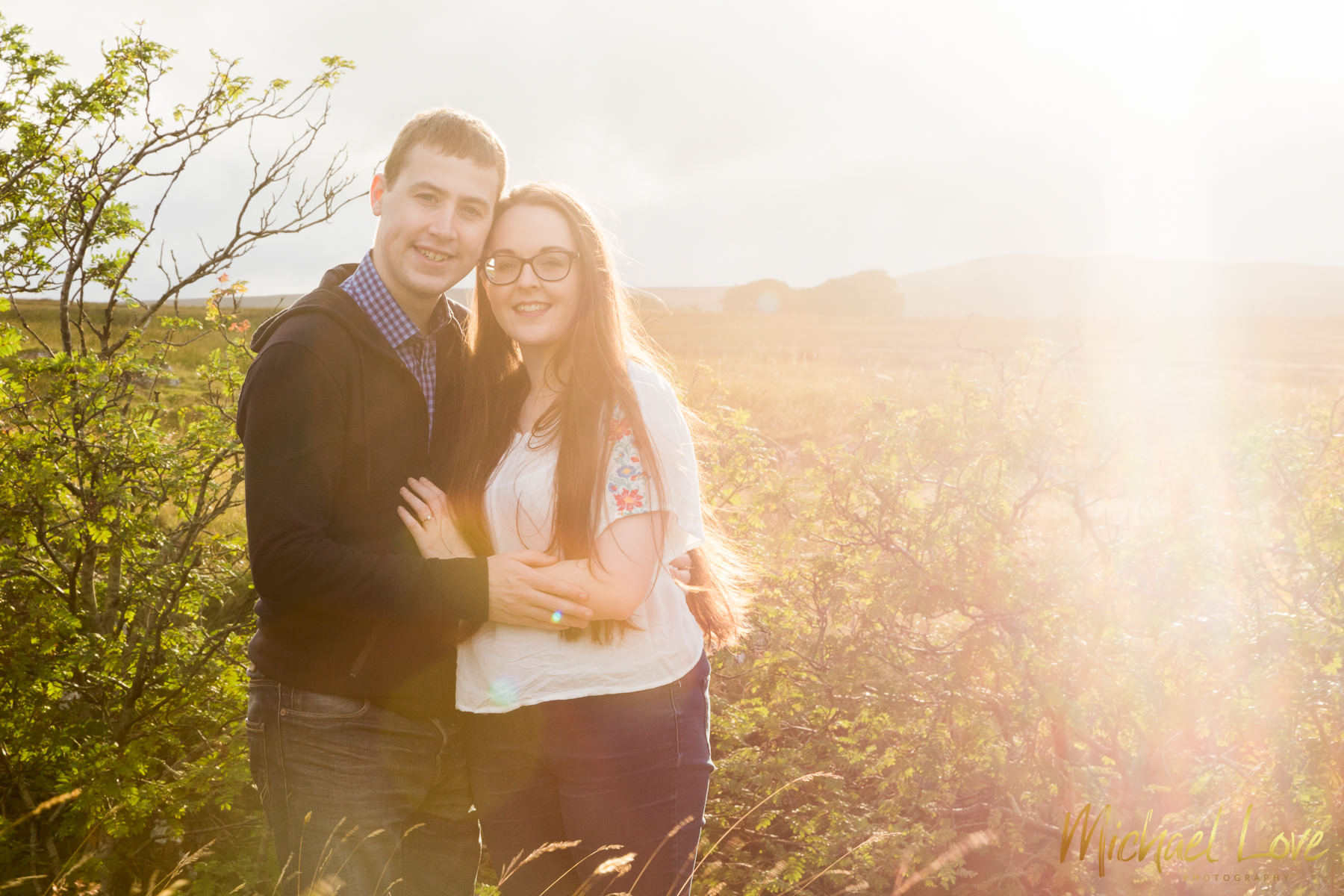 Engagement photo of young couple in countryside