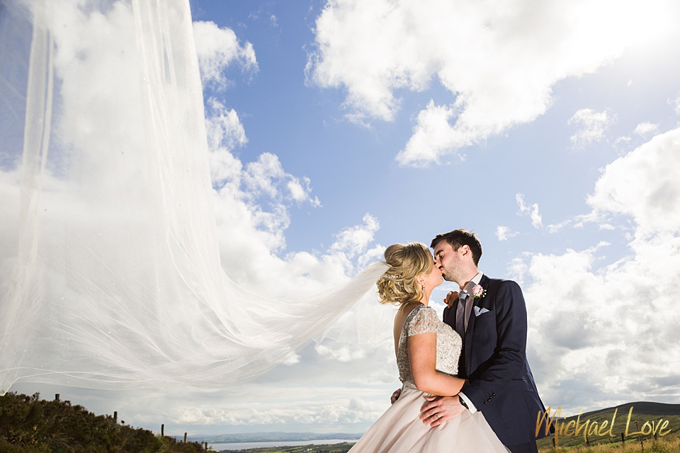 Wedding couple in Ireland with dramatic veil