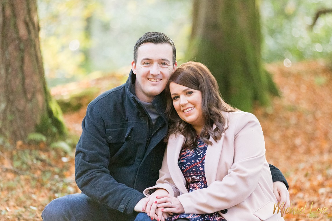 Engagement couple sitting in Donegal woods