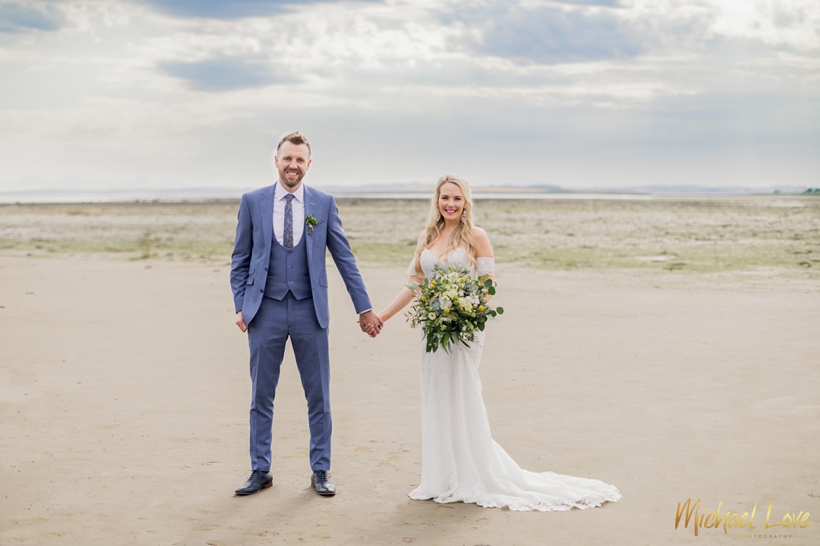 Wedding couple on the beach beside the Orange Tree House