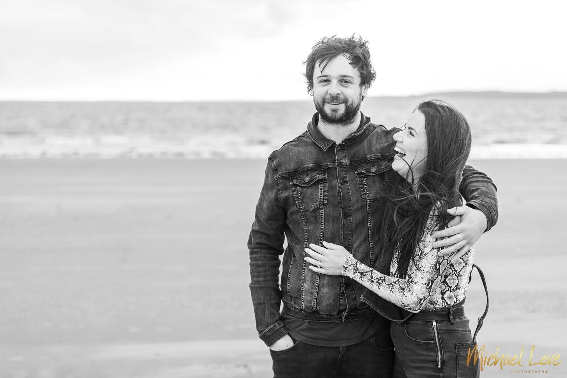 B&W photo of engaged couple on beach