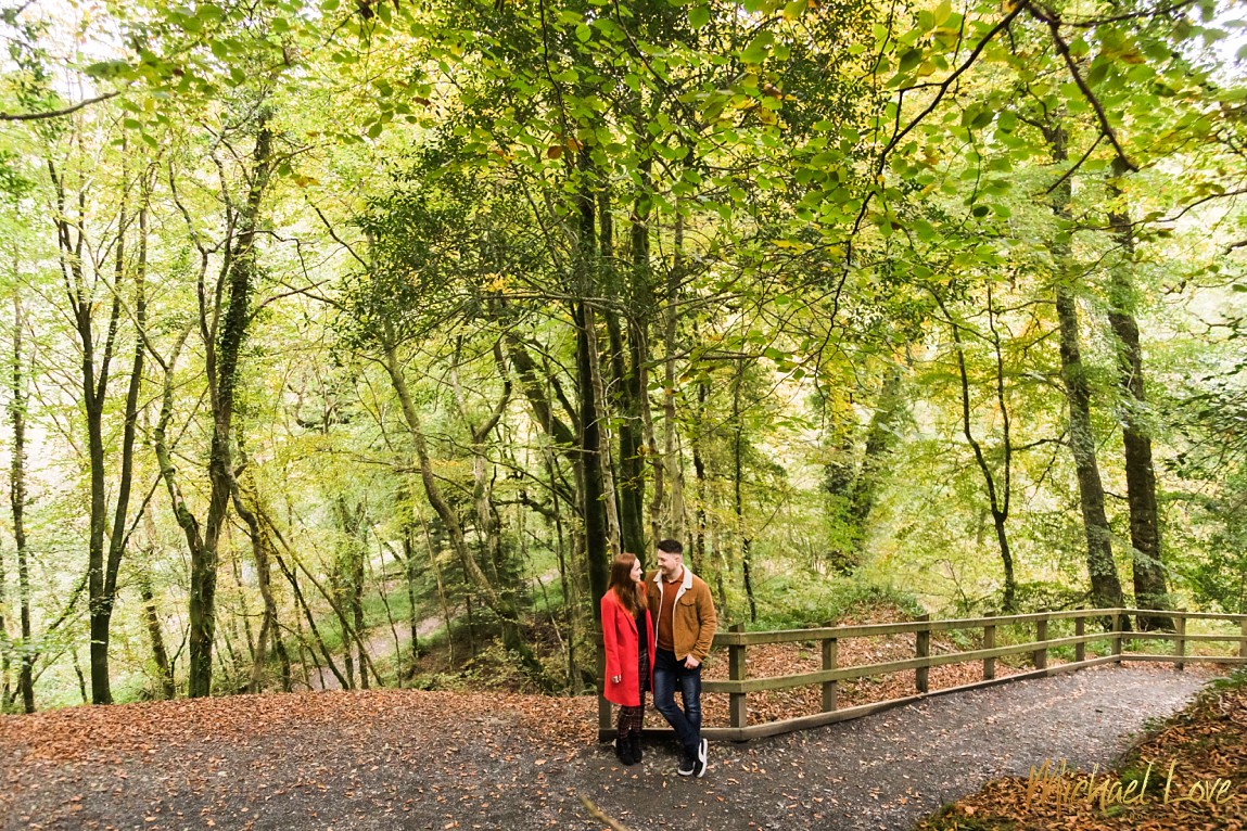 Engaged couple kissing in Ness Woods