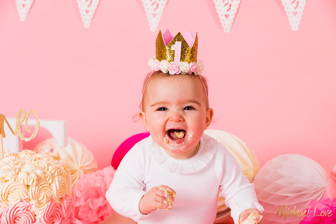 Excited baby girl in her cake smash photos