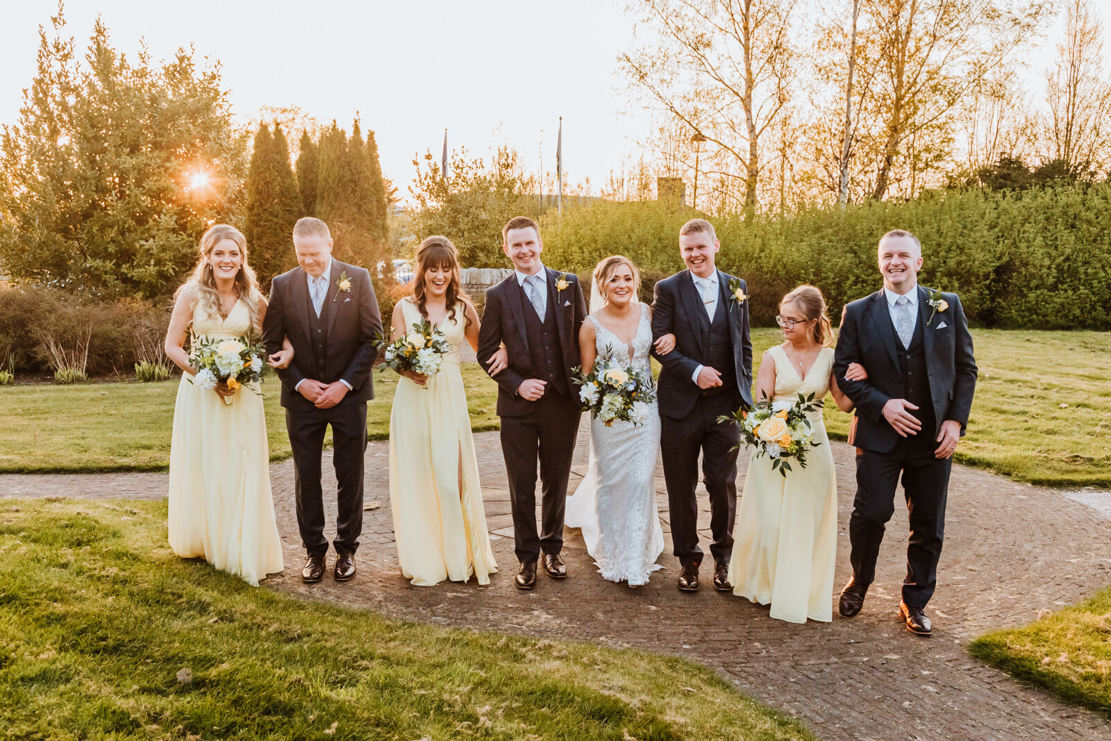 Bridal party walking in sunset