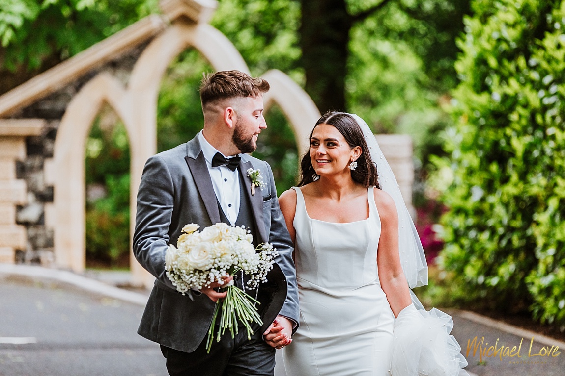 Wedding Couple walking in the grounds of Tullyglass House Hotel